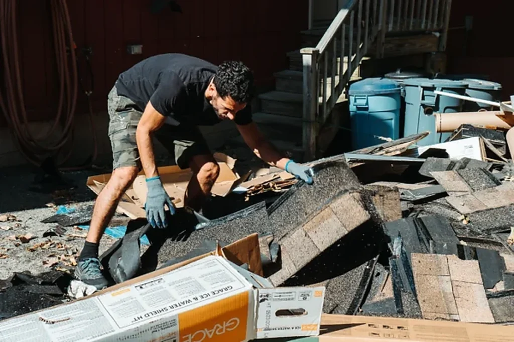 Specialty junk removal worker sorting and clearing construction debris and unwanted materials.