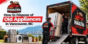 Haultra Junk Removal team loading an old refrigerator and household appliances into a junk removal truck in Vancouver, BC.